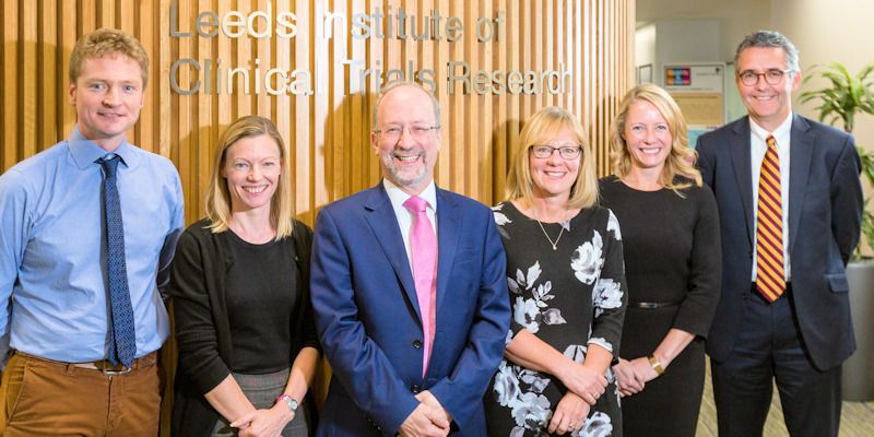 Six researchers smiling to camera