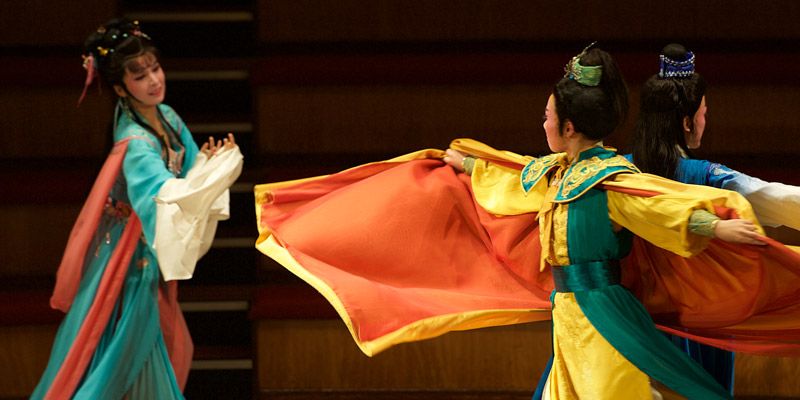 Three performers during a colourful Chinese theatre event at the University.