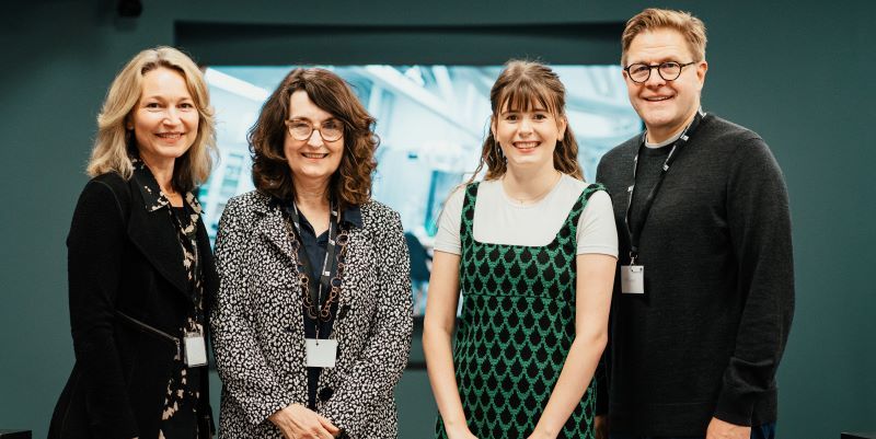 Four people - Margaret Korosec, Simone Buitendijk, Bethan Corner and Jeff Grabill - stand in front of a screen.