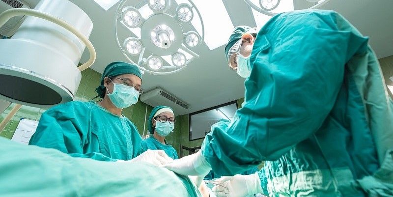 Surgeons performing surgery in an operating theatre