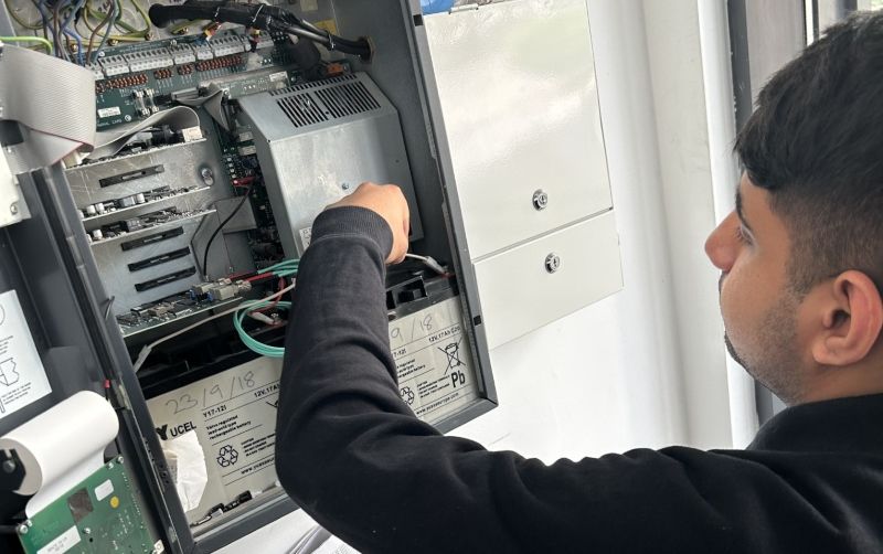 Adam Shafiq is pictured checking electrical work.