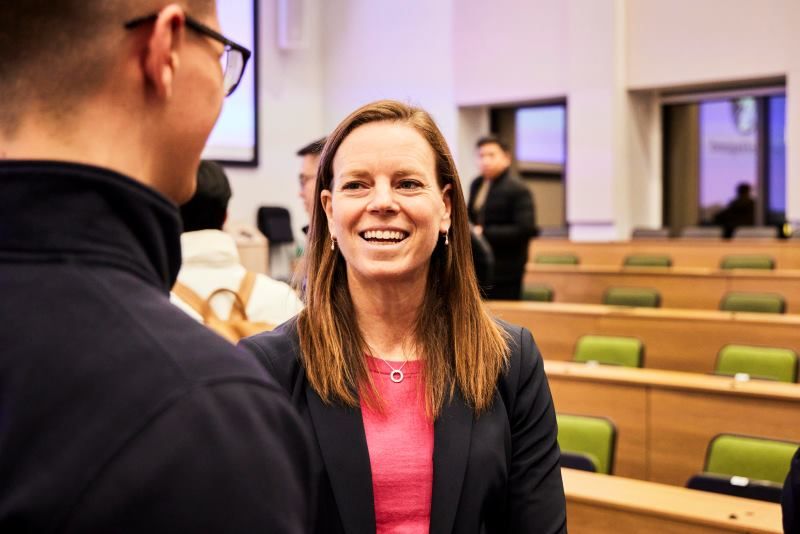 Megan Green speaking with a student after her speech. 