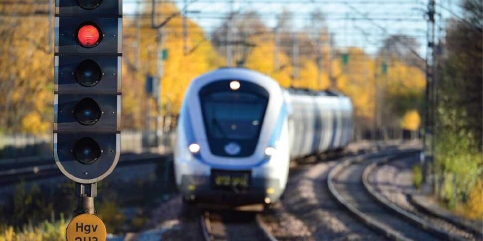 A train travelling on the railway approaches a signal