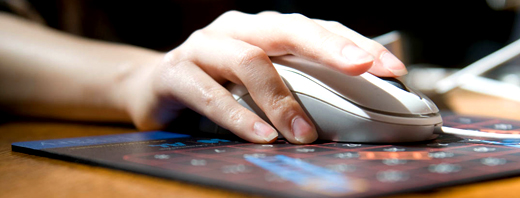Hand on mouse on mousemat 