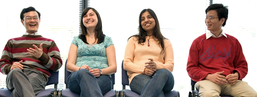 Smiling students of mixed nationality sitting in a row