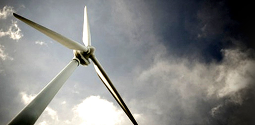Photograph of a large wind turbine against a cloudy sky.