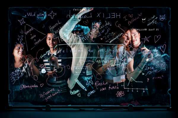 A group of people writing different words on a digital screen