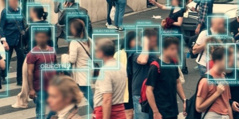 A busy zebra crossing with people rushing across it. Their faces are blurred. Computer-generated squares are layered over their faces with the text 'object' stamped across the side.