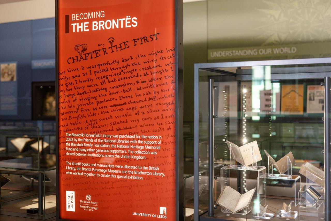 Becoming the Brontës on display in the Treasures of the Brotherton Gallery. A selection of little books and the welcome panel are included in the photo.