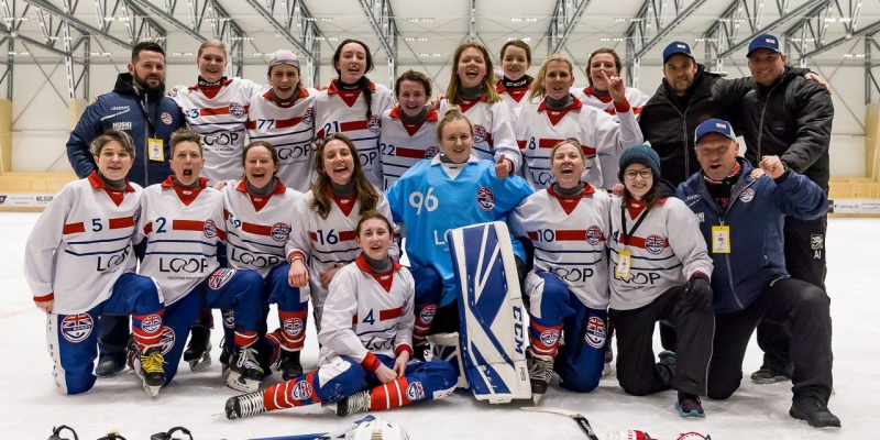 The GB women's bandy team celebrates on an ice rink after their successful World Cup 