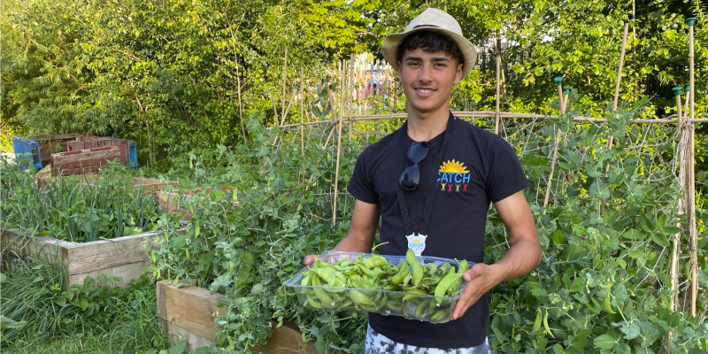 Iosif holding a box of fresh vegetables