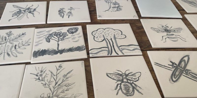 Tiles hand-painted by Mafwa participants, featuring bees, plants, trees, moths and more
