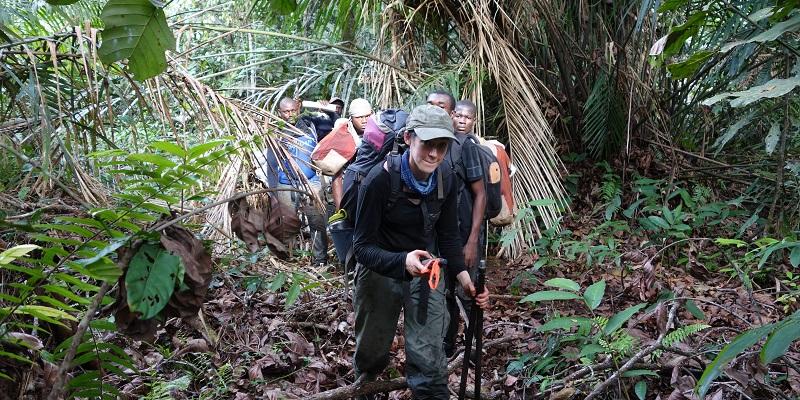 Researchers hike into the swamp forest to take peat samples.