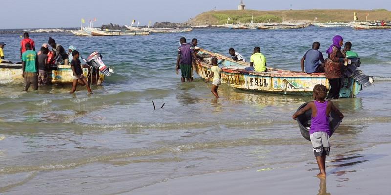 The image shows people seither setting out or returning from fishing on one of the African great lakes. They are in open fishing boats.