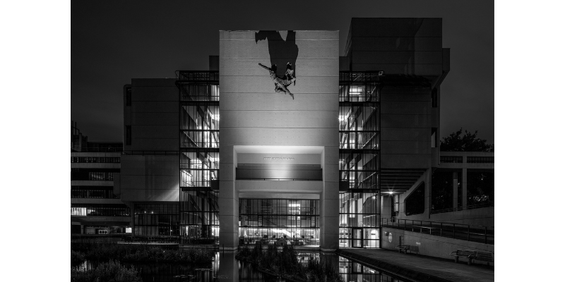 Black and white image of the Roger Stevens building at night