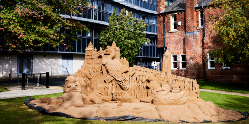 Large sand sculpture of the Great Hall, the Parkinson Building, a heron, a rabbit and a duck
