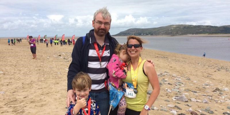 Peter and Laura Smallbone and their family pose on a beach