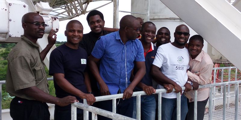 Nine researchers, including Saul Phiri, who gained their PhDs with the Development in Africa with Radio Astronomy (DARA) project. They are smiling at the camera.