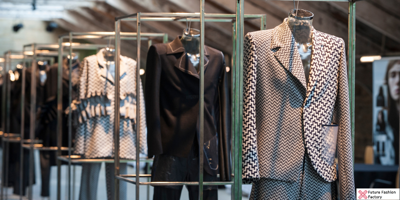 Black and white blazers displayed in a fashion showcase.