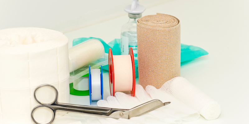 Bandages, plasters, medicine and scissors.