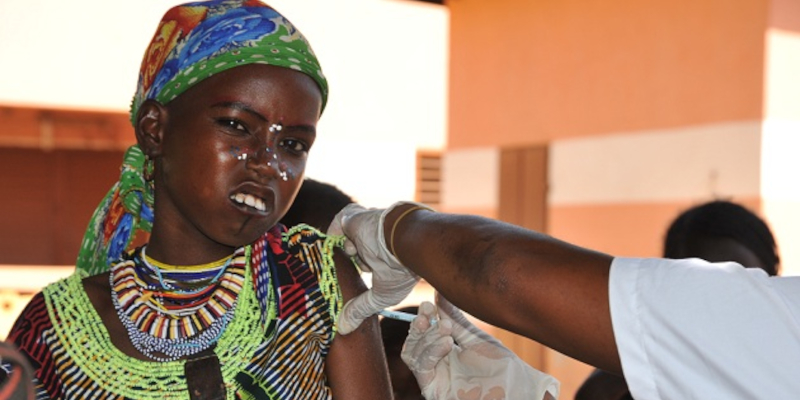 African girl receiving vaccine injection.