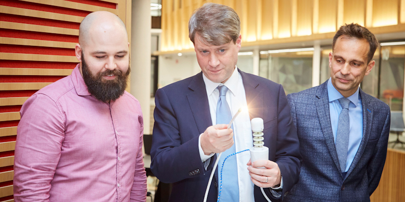 From left, Dr James Chandler, Research Fellow in Medical Robotics, demonstrates a prototype to Chris Skidmore and Professor Pietro Valdastri, Chair in Robotics and Autonomous Systems in the School of Electronic and Engineering