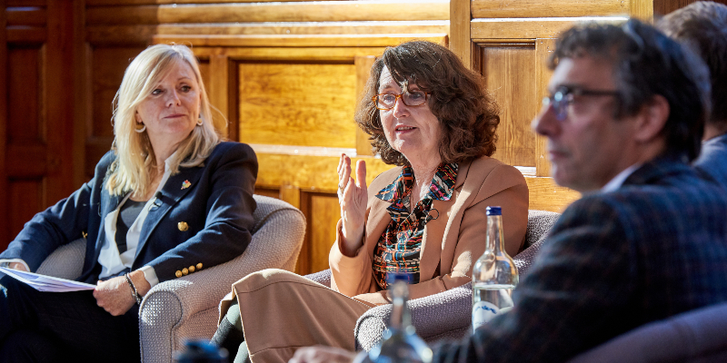 Vice-Chancellor Professor Simone Buitendijk on stage and speaking to the audience with Tracy Brabin to the left and Professor Piers Forster to the right