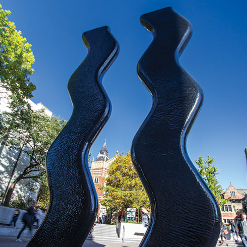 A tall black sculpture of two parallel waved lines called 'Sign for Art'