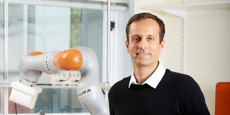 Professor Pietro Valdastri in the STORM lab, standing in front of a medical capsule robot machine.