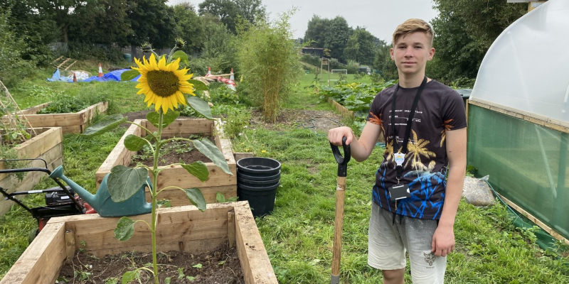 Moise standing next to a raised bed