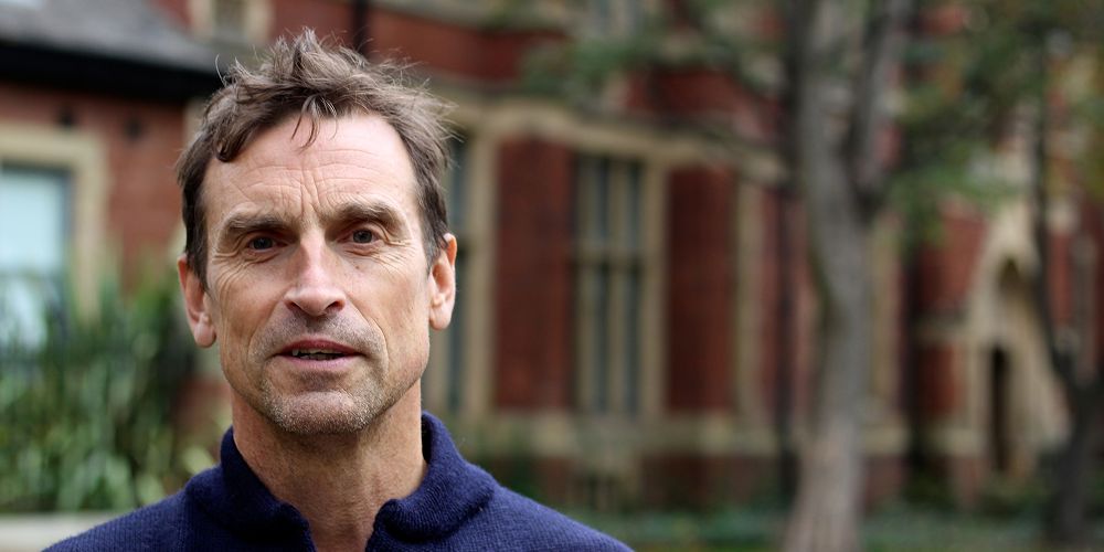 A profile image of Kenton Cool standing outside the Baines at the University of Leeds