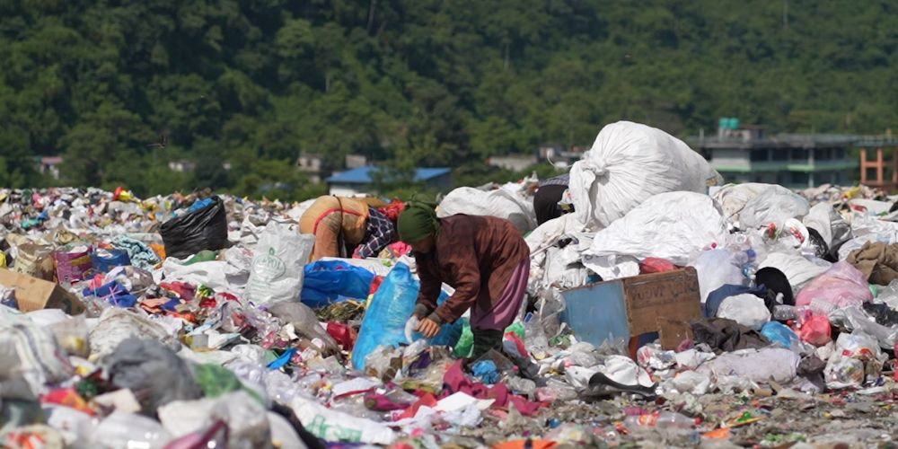 Person scavenges on a landfill site in South Asia. Photo credit: HERD International