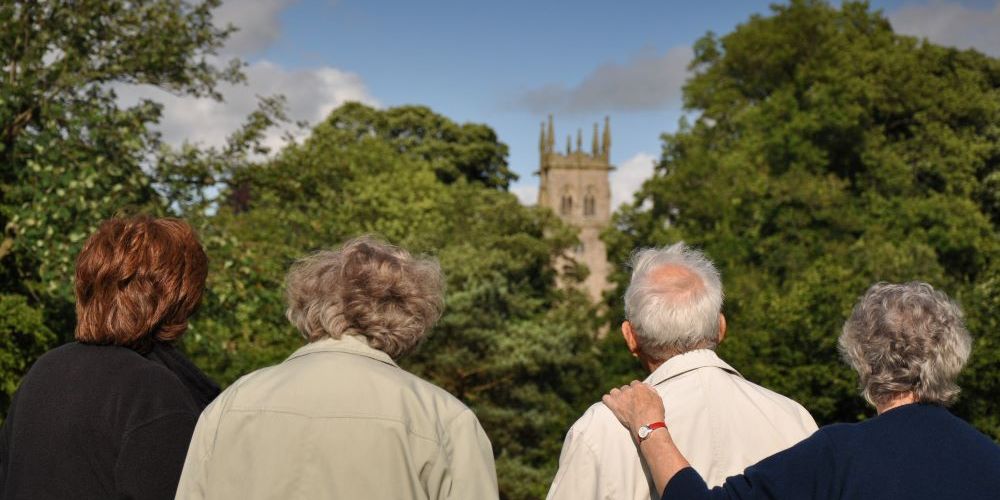 Four people look at a church in Yorkshire.