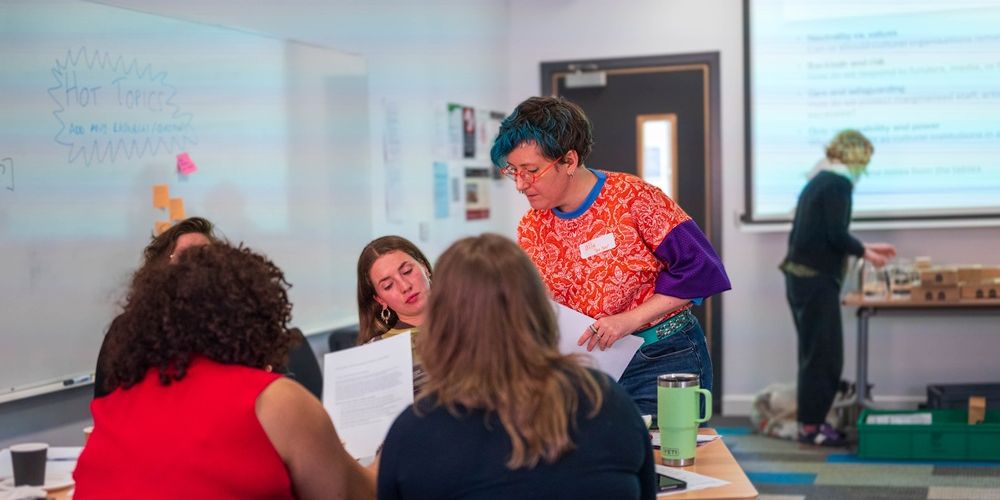 A facilitator delivering a workshop to a group of people