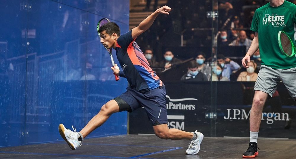 Saurav Ghosal playing squash, swings his racket on court