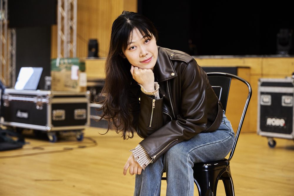 Student posing on a chair