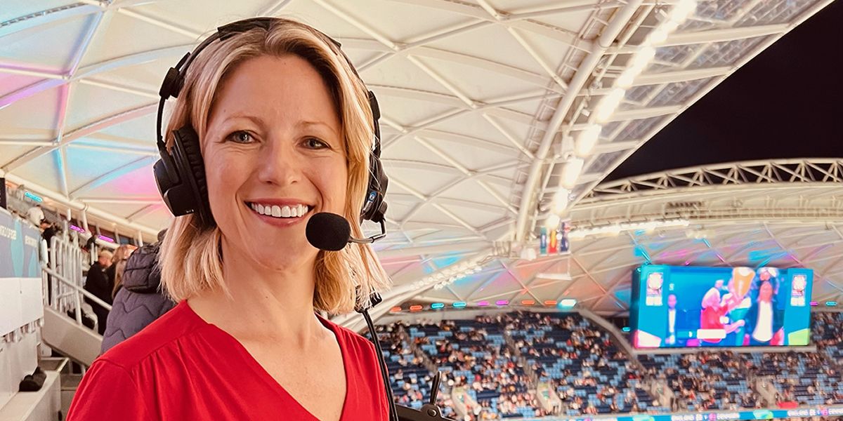 Jacqui Oatley wearing a headset microphone in a stadium