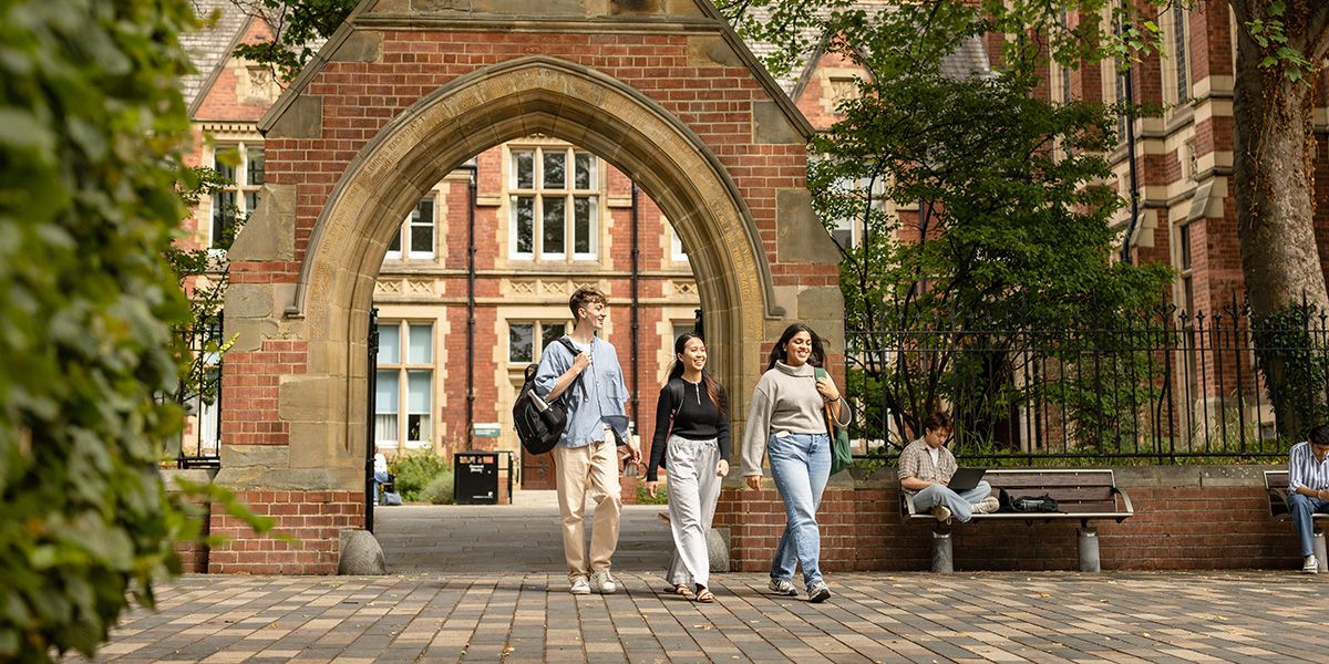 Three students walking through Clothworker's Court.