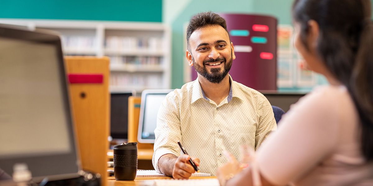 A student working with a University member of staff in the Language Centre.