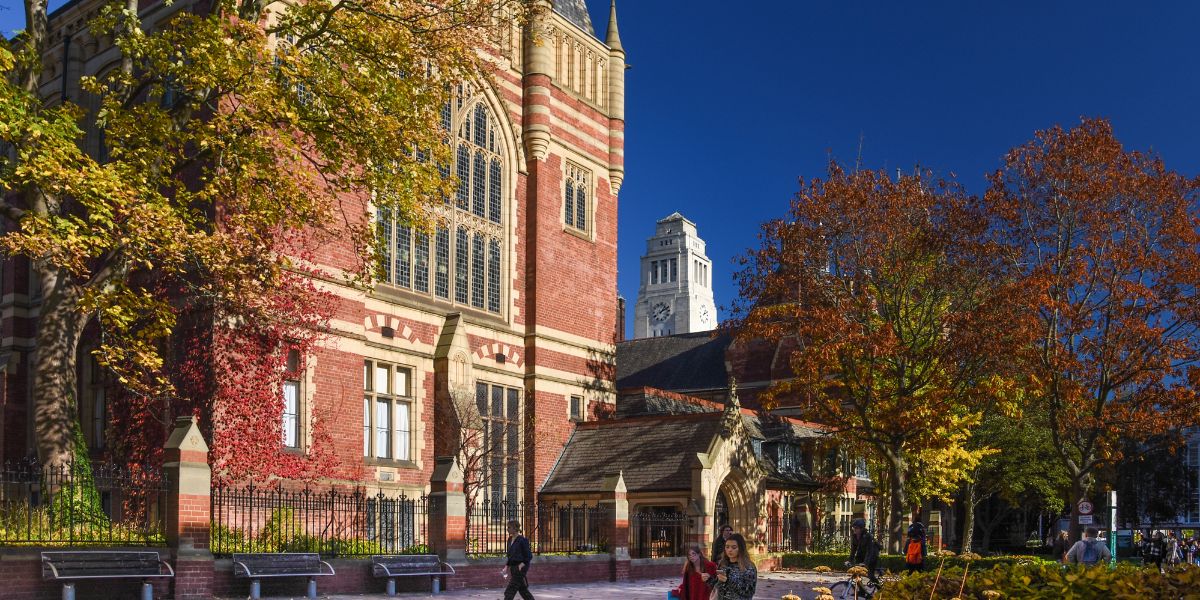 The Great Hall with trees nearby and the Parkinson clock tower.