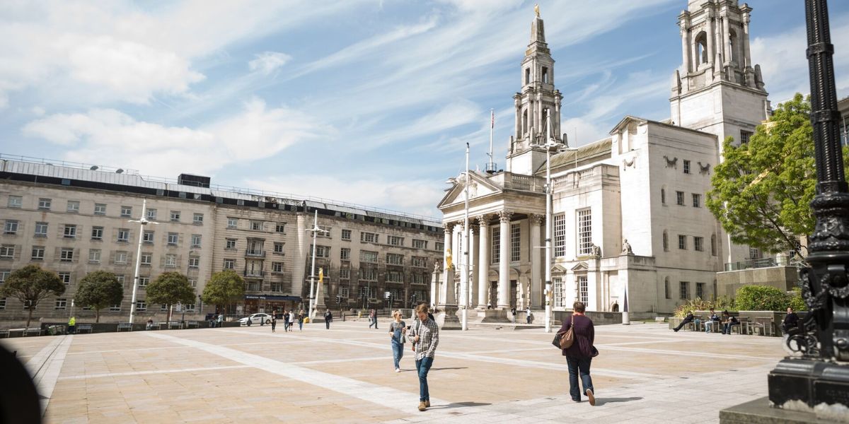 The Civic Hall in Millenium Square, a white stone building with two turrets at the sides that have owls on the top.