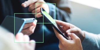 Hands clutching smartphones