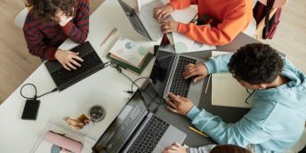 Teenage students working on computers