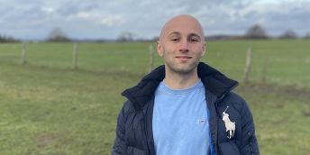 Ryan Bell standing in front of a field.