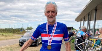 Brian Cookson OBE after a cycling race, wearing a medal
