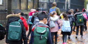Children walking in to primary school in autumnal weather