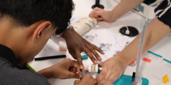 Close up of a pupil doing an activity involving building a model