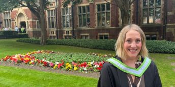 Tv development executive Gillian Brown in her graduation gowns stood in front of the Great Hall.