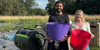 Hussain with Elise holding compost buckets.