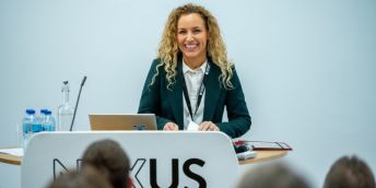 Katie White MP speaking at a lectern